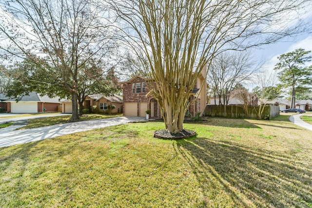 view of property hidden behind natural elements featuring brick siding, concrete driveway, an attached garage, a front yard, and fence