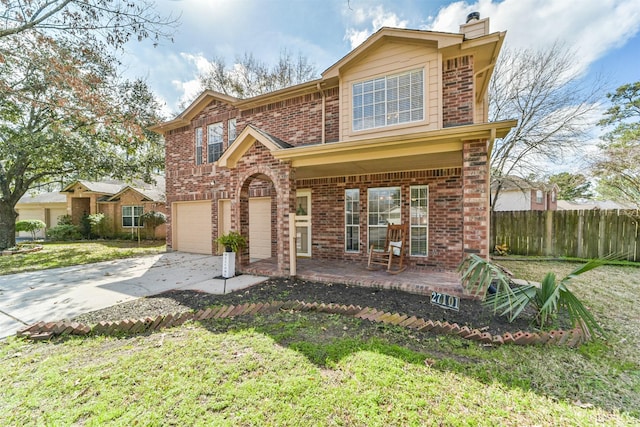 view of front of house with a garage, a porch, and a front yard