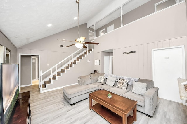 living room featuring beamed ceiling, ceiling fan, high vaulted ceiling, and light hardwood / wood-style floors