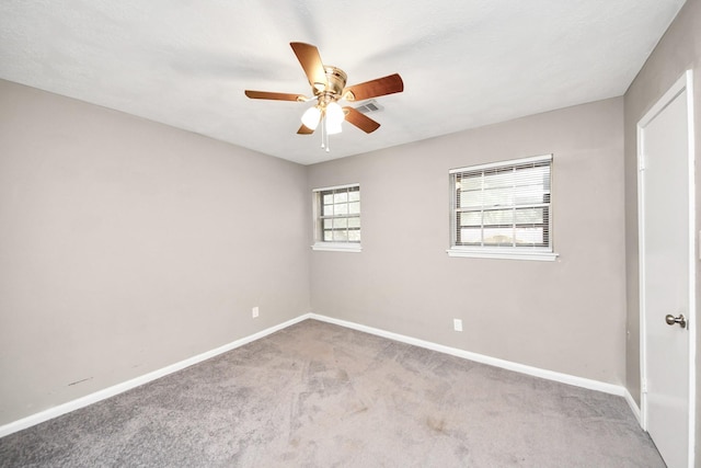 spare room featuring light colored carpet and ceiling fan