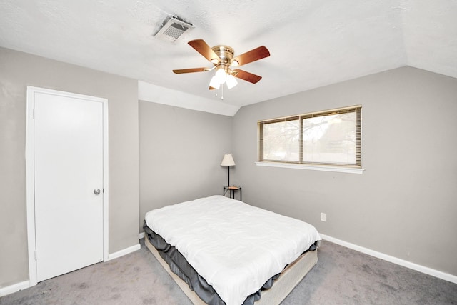 carpeted bedroom with vaulted ceiling and ceiling fan