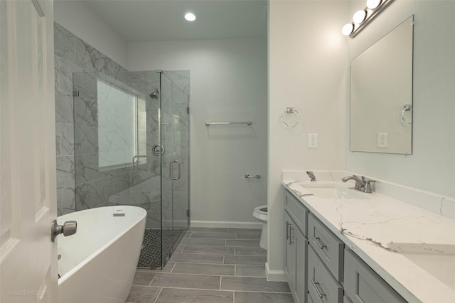 full bathroom with vanity, shower with separate bathtub, and toilet