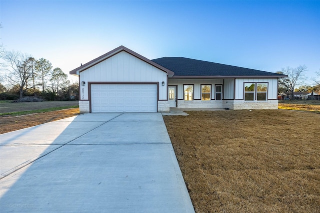 view of front of property featuring a garage and a front lawn