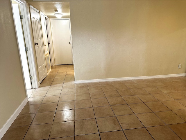 hallway featuring light tile patterned flooring