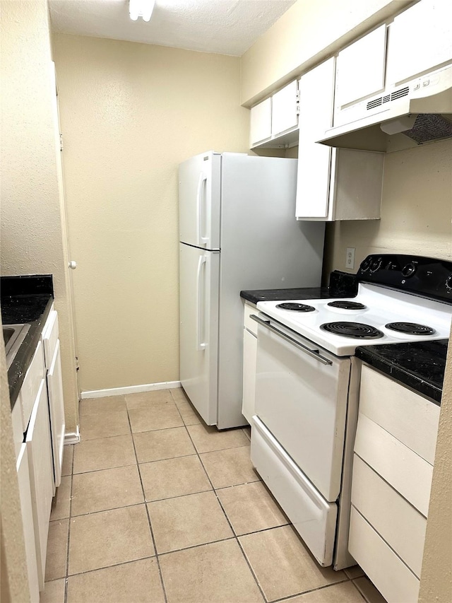 kitchen featuring light tile patterned flooring, white cabinets, and white electric range oven