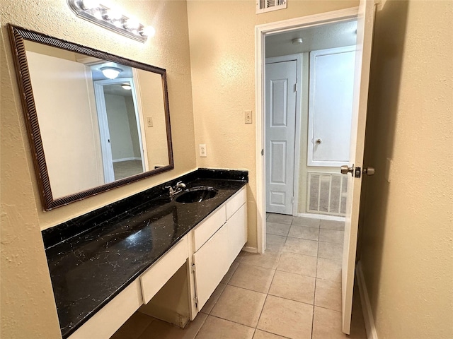 bathroom featuring tile patterned flooring and vanity