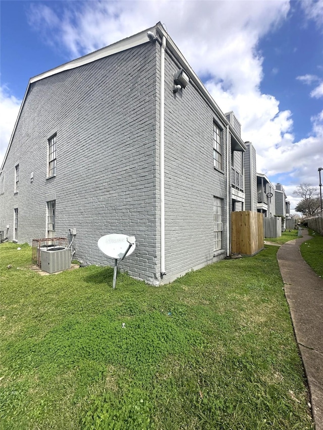 view of property exterior featuring cooling unit and a yard