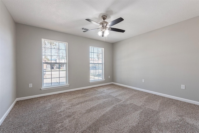 spare room with ceiling fan, a textured ceiling, and carpet