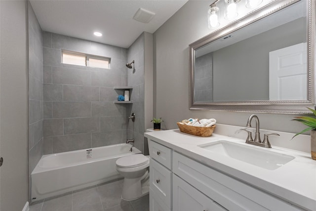 full bathroom with tiled shower / bath, vanity, toilet, and tile patterned flooring