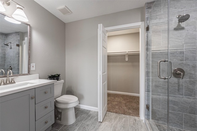 bathroom with vanity, toilet, and an enclosed shower