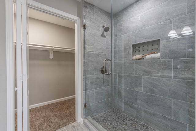 bathroom featuring a shower with door