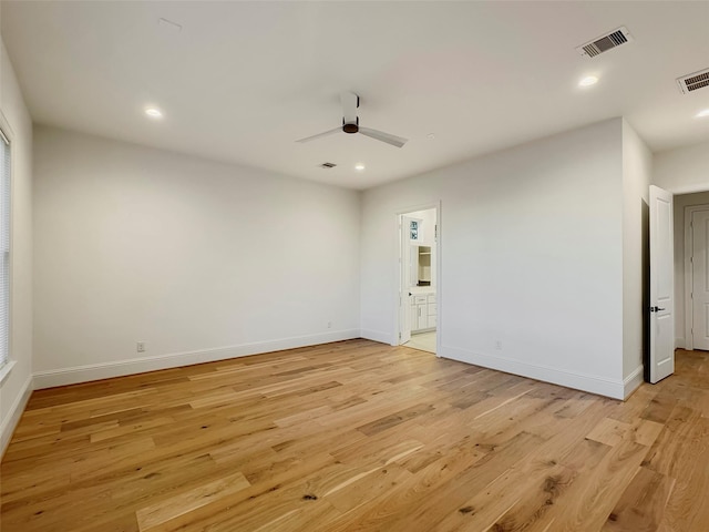 spare room with light hardwood / wood-style flooring and ceiling fan