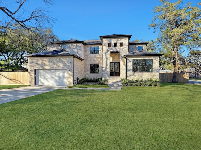 view of front facade with a garage and a front yard