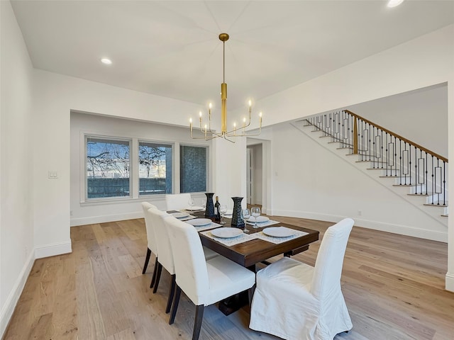 dining area featuring a notable chandelier and light hardwood / wood-style flooring