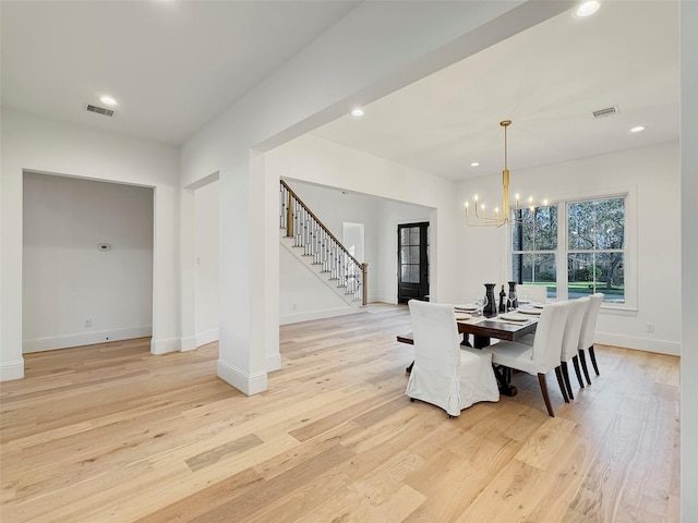 dining room featuring light hardwood / wood-style flooring and a notable chandelier