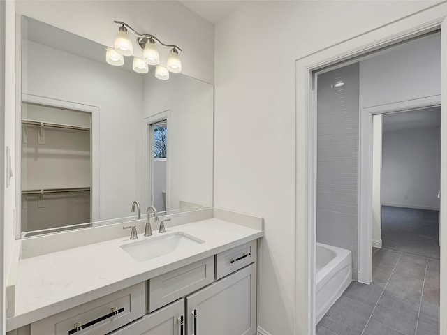 bathroom with tile patterned floors, vanity, and a bathtub