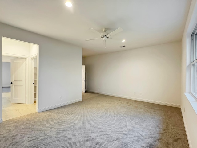 carpeted empty room with ceiling fan