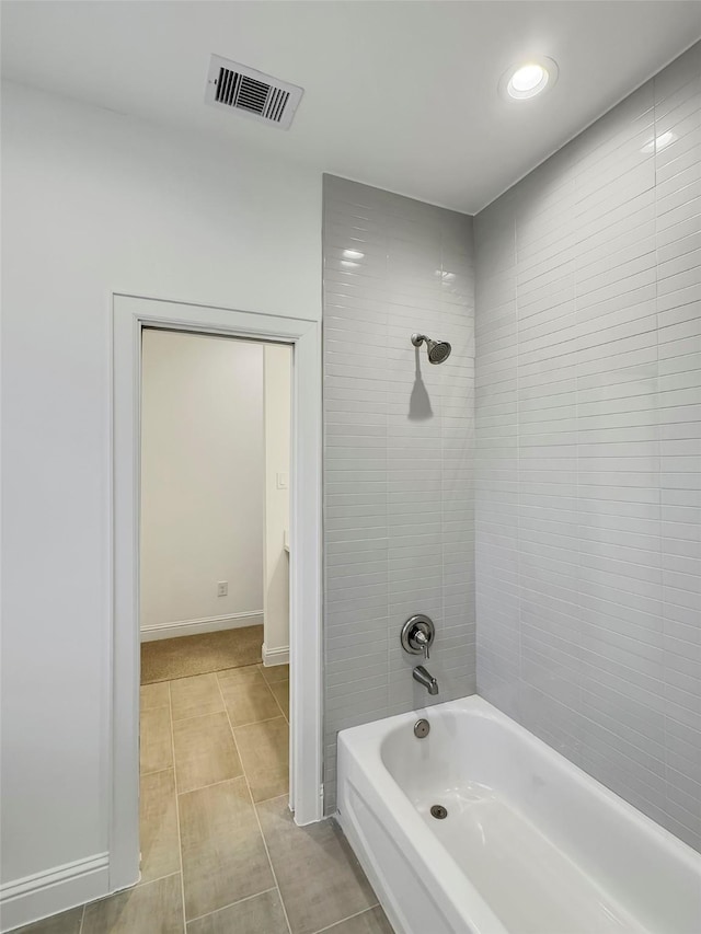 bathroom with tile patterned floors and tiled shower / bath