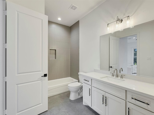 full bathroom with tiled shower / bath combo, vanity, tile patterned floors, and toilet