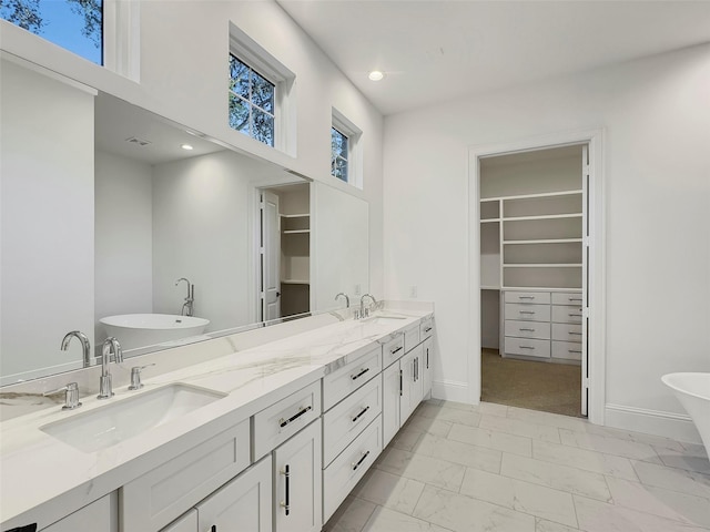 bathroom with vanity and a tub