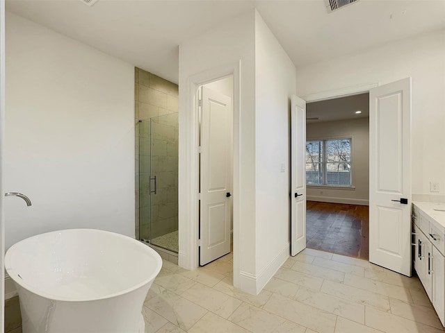 bathroom with vanity and independent shower and bath