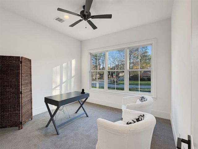 carpeted office space with ceiling fan