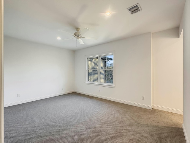 carpeted empty room featuring ceiling fan