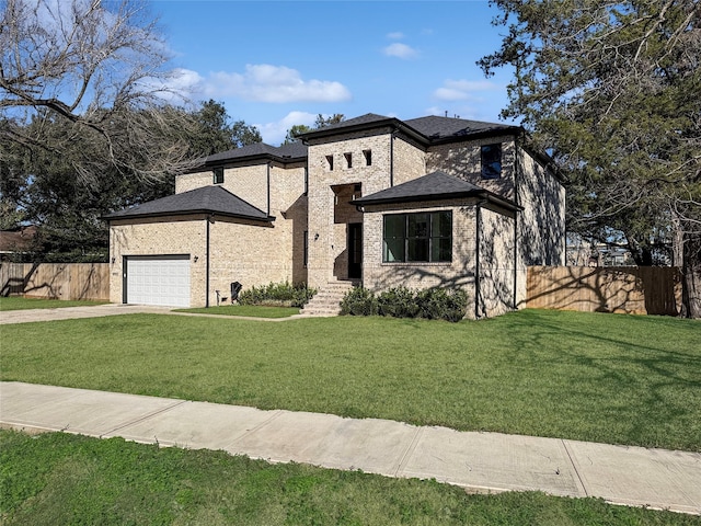 view of front facade featuring a garage and a front lawn