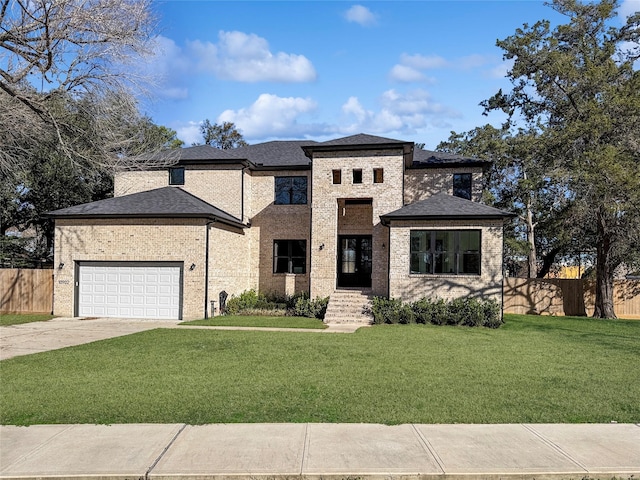 view of front of property with a garage and a front yard