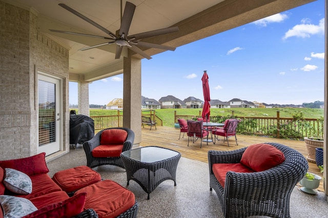 view of patio / terrace featuring a wooden deck, ceiling fan, and grilling area