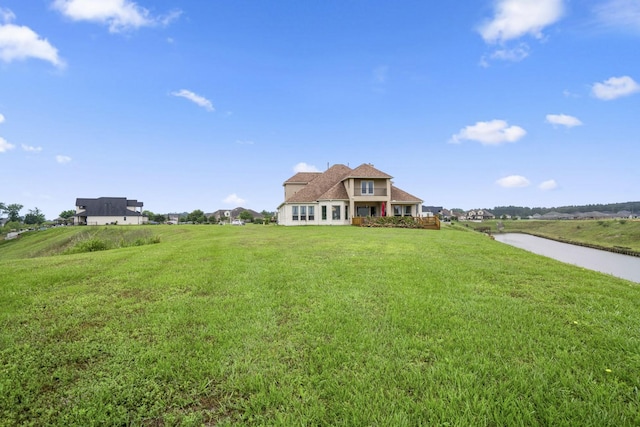 view of front facade with a water view and a front yard