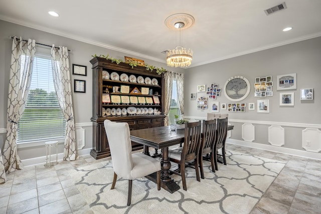 dining space featuring an inviting chandelier and ornamental molding