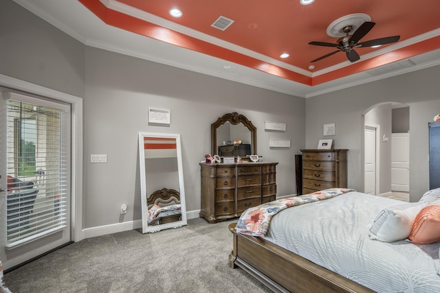 bedroom with a raised ceiling, crown molding, carpet floors, and access to outside