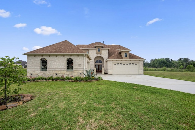 view of front of property with a garage and a front lawn