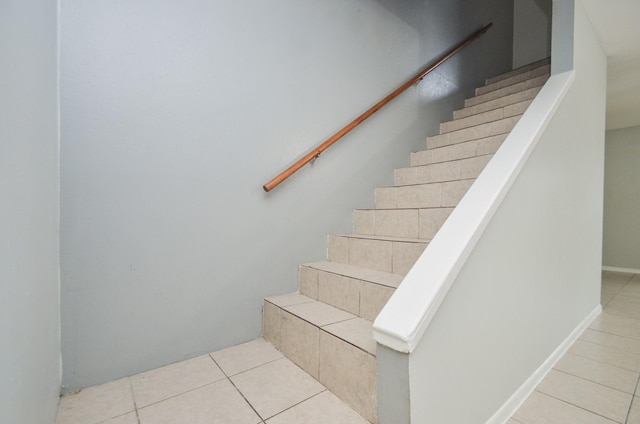 staircase with tile patterned flooring