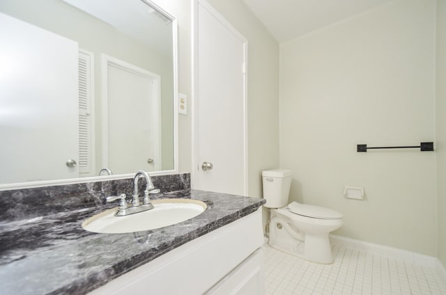 bathroom featuring tile patterned flooring, vanity, and toilet