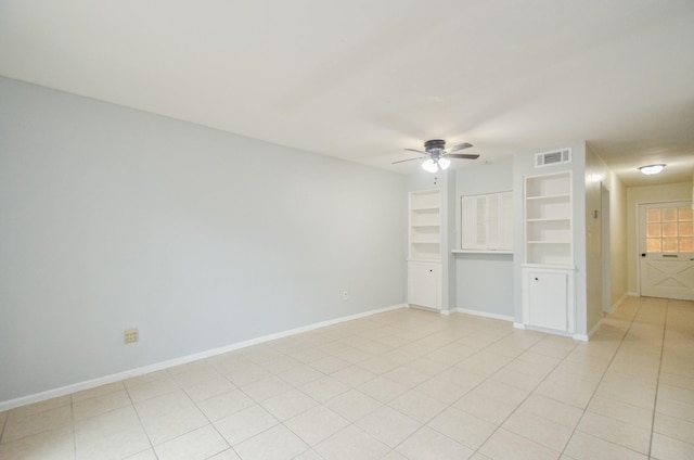 unfurnished living room featuring light tile patterned floors, ceiling fan, and built in shelves