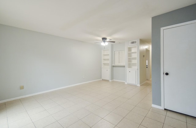 unfurnished living room with light tile patterned flooring, ceiling fan, and built in shelves