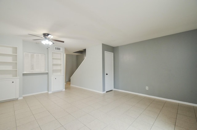 unfurnished room with light tile patterned floors, ceiling fan, and built in shelves