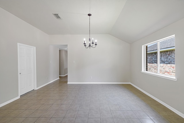 tiled spare room featuring vaulted ceiling and a chandelier