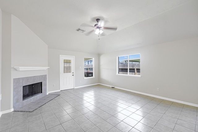 unfurnished living room featuring ceiling fan, a tile fireplace, and light tile patterned floors