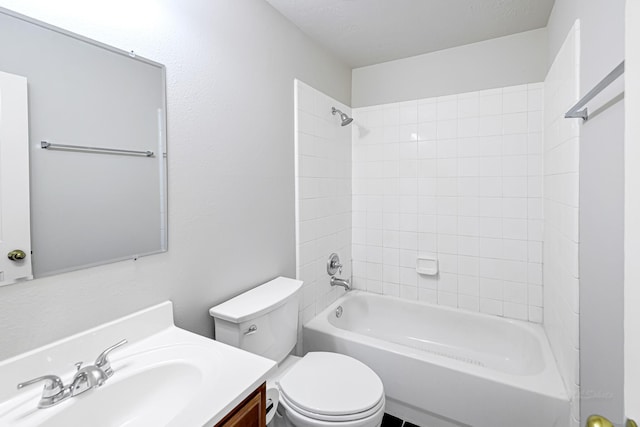 full bathroom with vanity, tiled shower / bath combo, and toilet