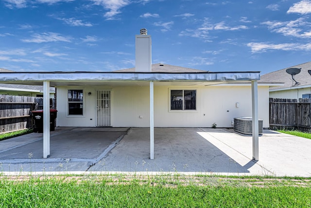 back of house with central AC and a patio