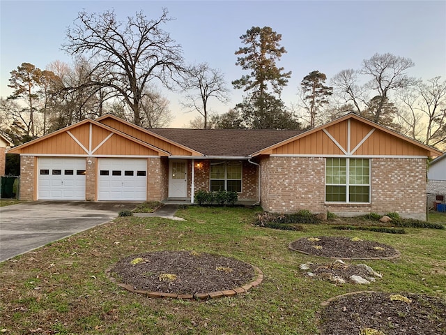 ranch-style house featuring a front lawn, brick siding, a garage, and driveway