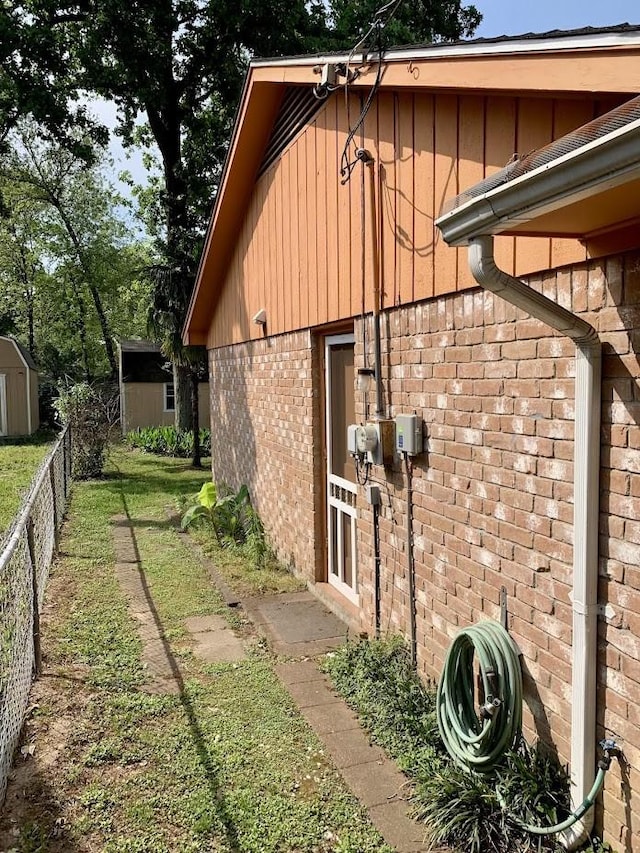 view of home's exterior featuring brick siding and board and batten siding