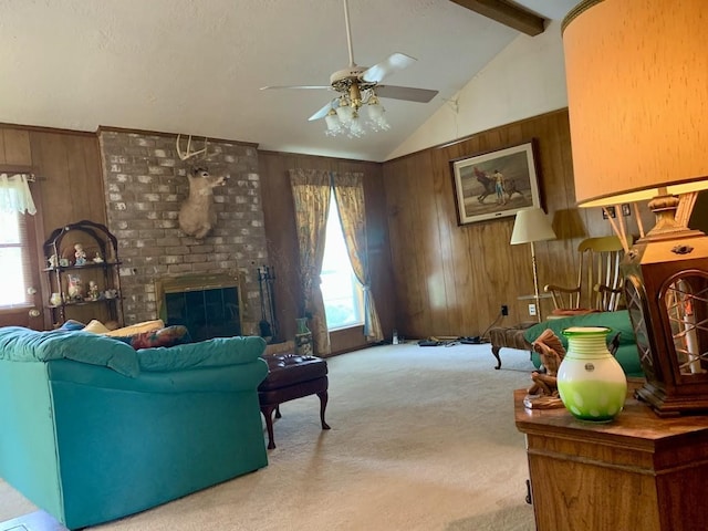 living area with wood walls, carpet floors, healthy amount of natural light, a ceiling fan, and a fireplace