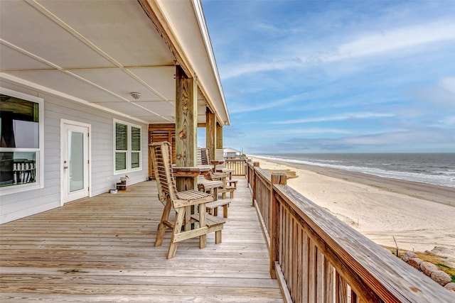 deck featuring a water view and a beach view