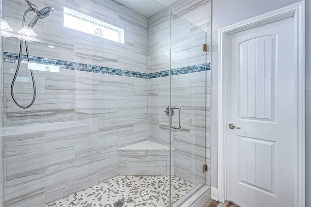 bathroom featuring a shower with shower door