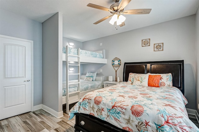 bedroom with ceiling fan and light hardwood / wood-style flooring