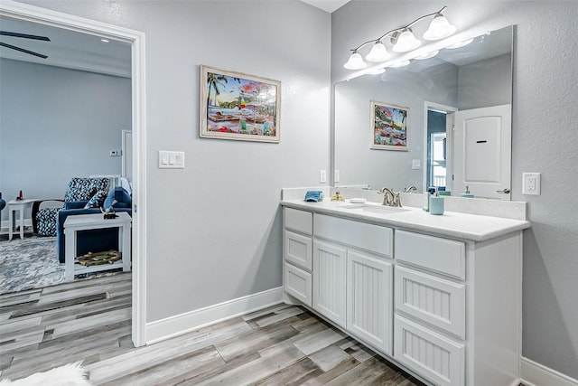 bathroom with vanity, hardwood / wood-style flooring, and ceiling fan